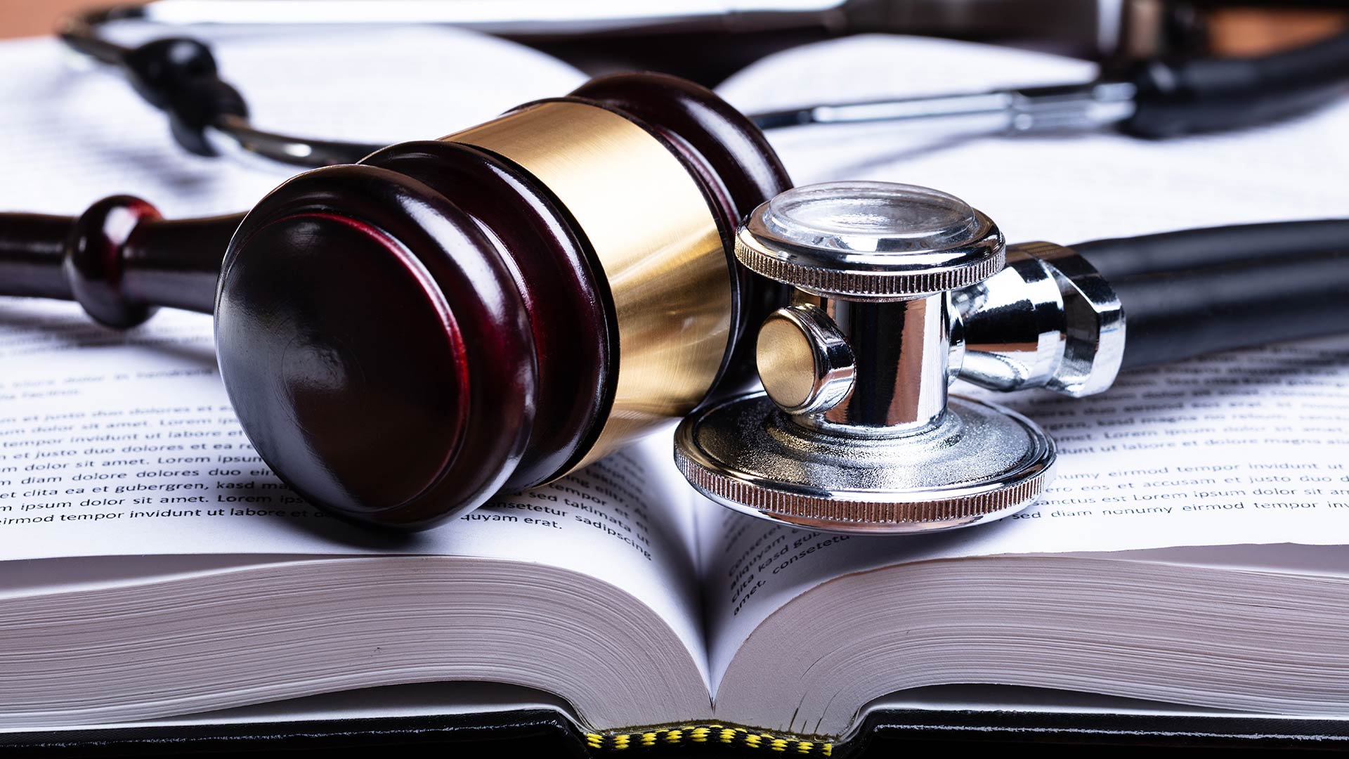 stethoscope and gavel with medical books